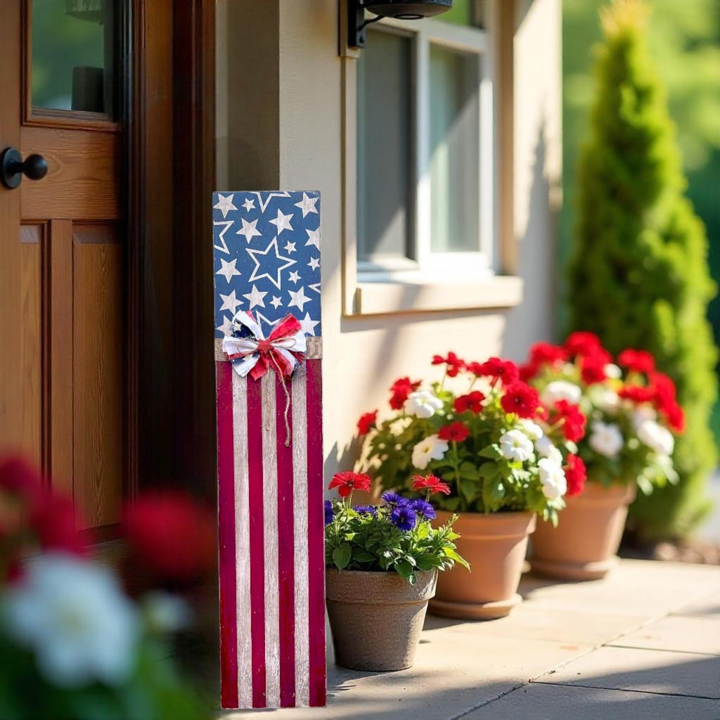 Rustic Americana flag porch leaner hand-painted navy star field and red white distressed stripes with patriotic rag ribbon bow close up detail showing star field and bow