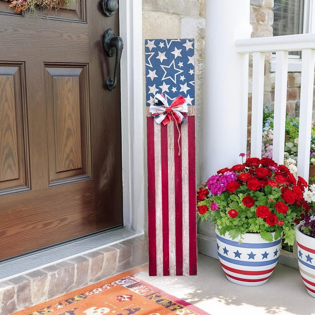 Rustic Americana flag porch leaner hand-painted navy star field and red white distressed stripes with patriotic rag ribbon bow product hero shot on white background