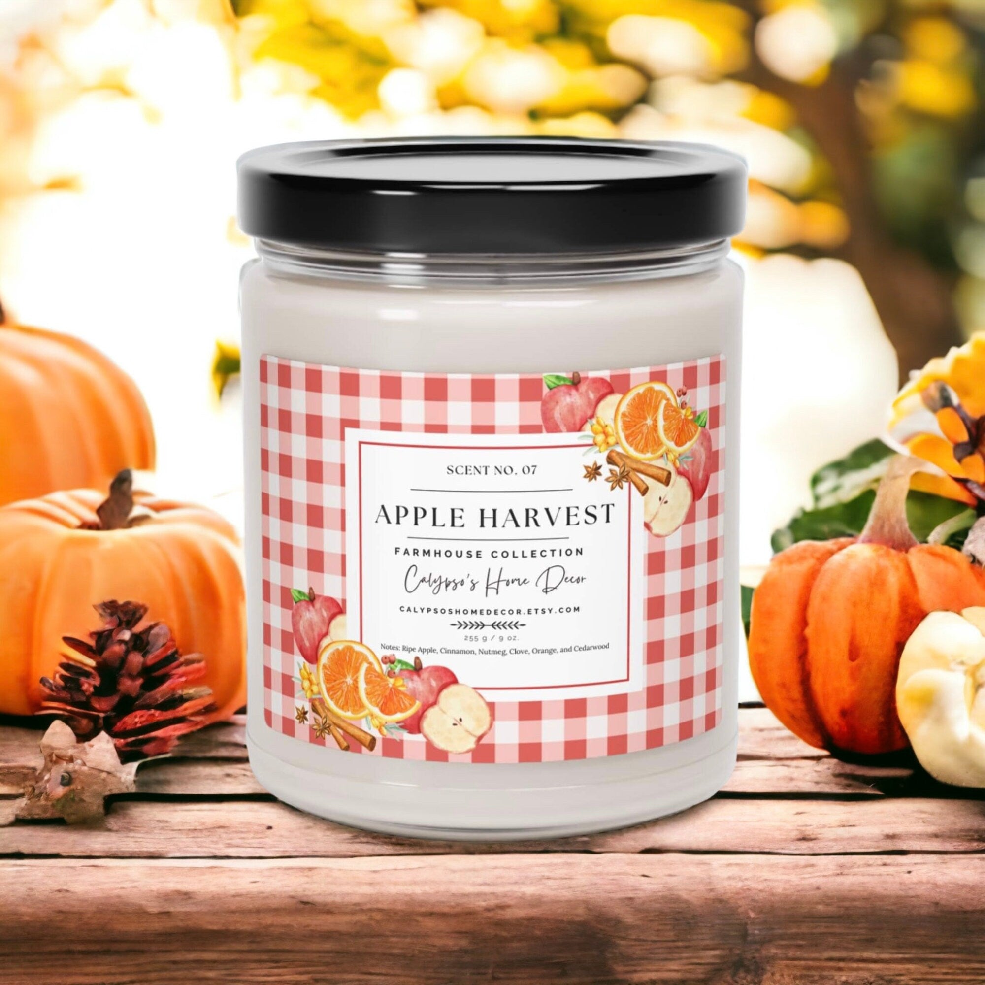 Apple Harvest candle on wood table with apple pie and mini pumpkins in background