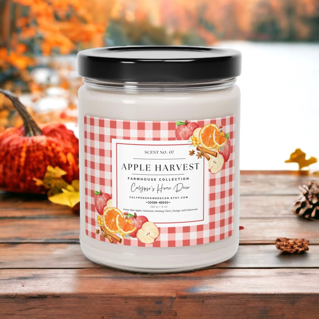 Apple Harvest candle styled with fall pumpkins and autumn leaves on rustic wood surface