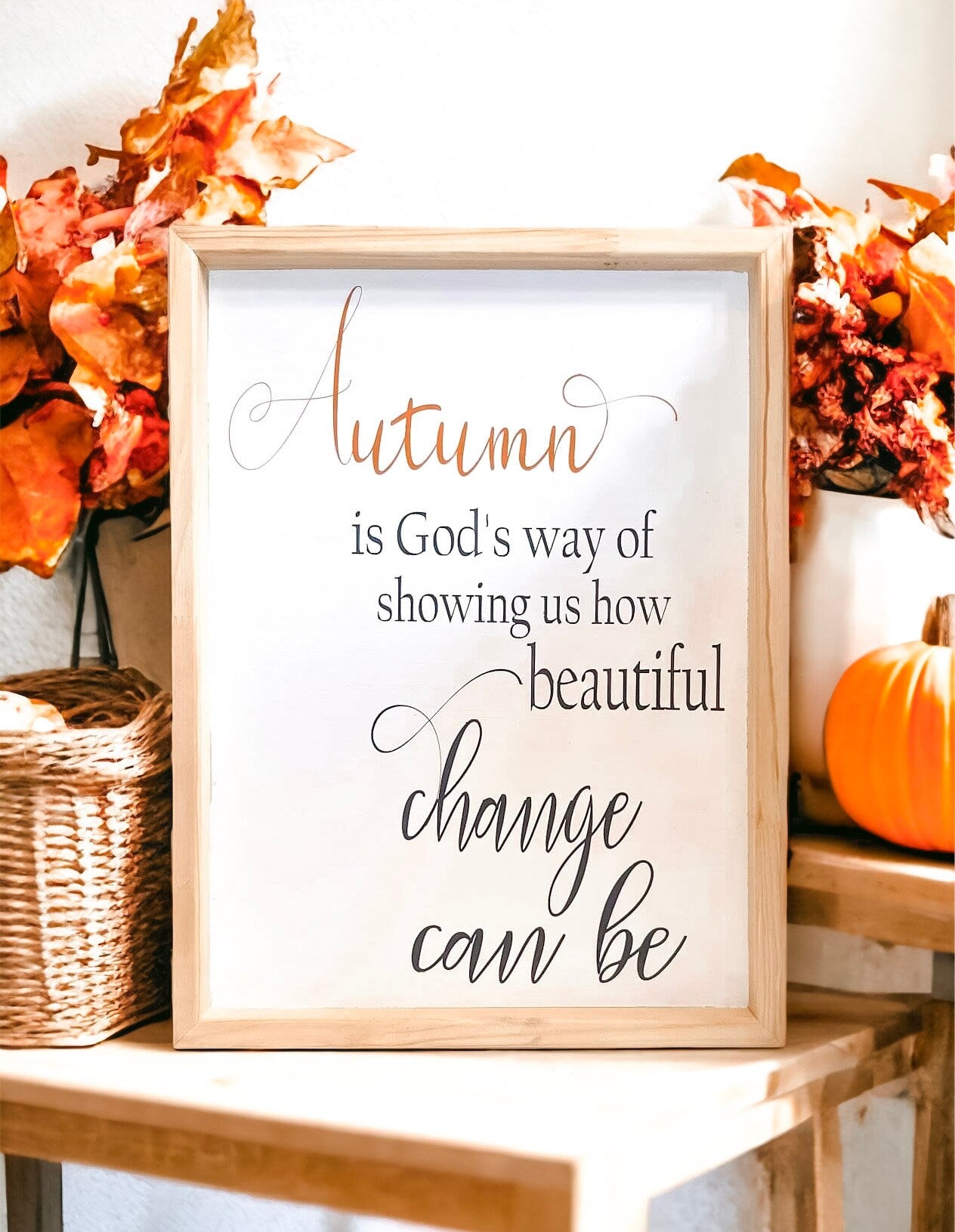 Autumn is Gods Way framed wood sign with copper and black lettering in whitewashed birch frame on rustic grey wood shiplap mantel with fall leaves and white pumpkin