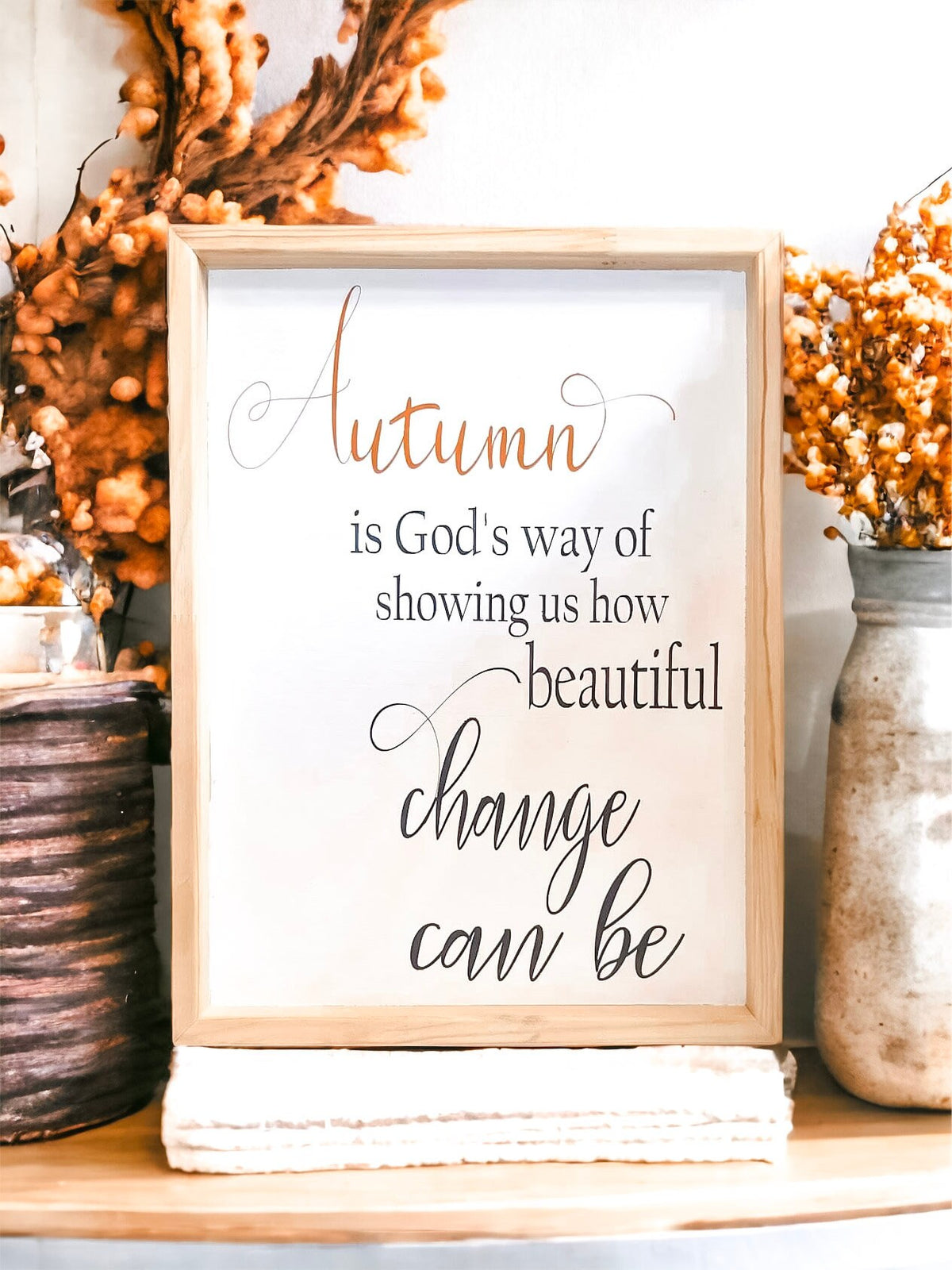 Autumn is Gods Way framed wood sign with copper and black lettering in whitewashed birch frame on wood console with white candle and orange berry wreath above