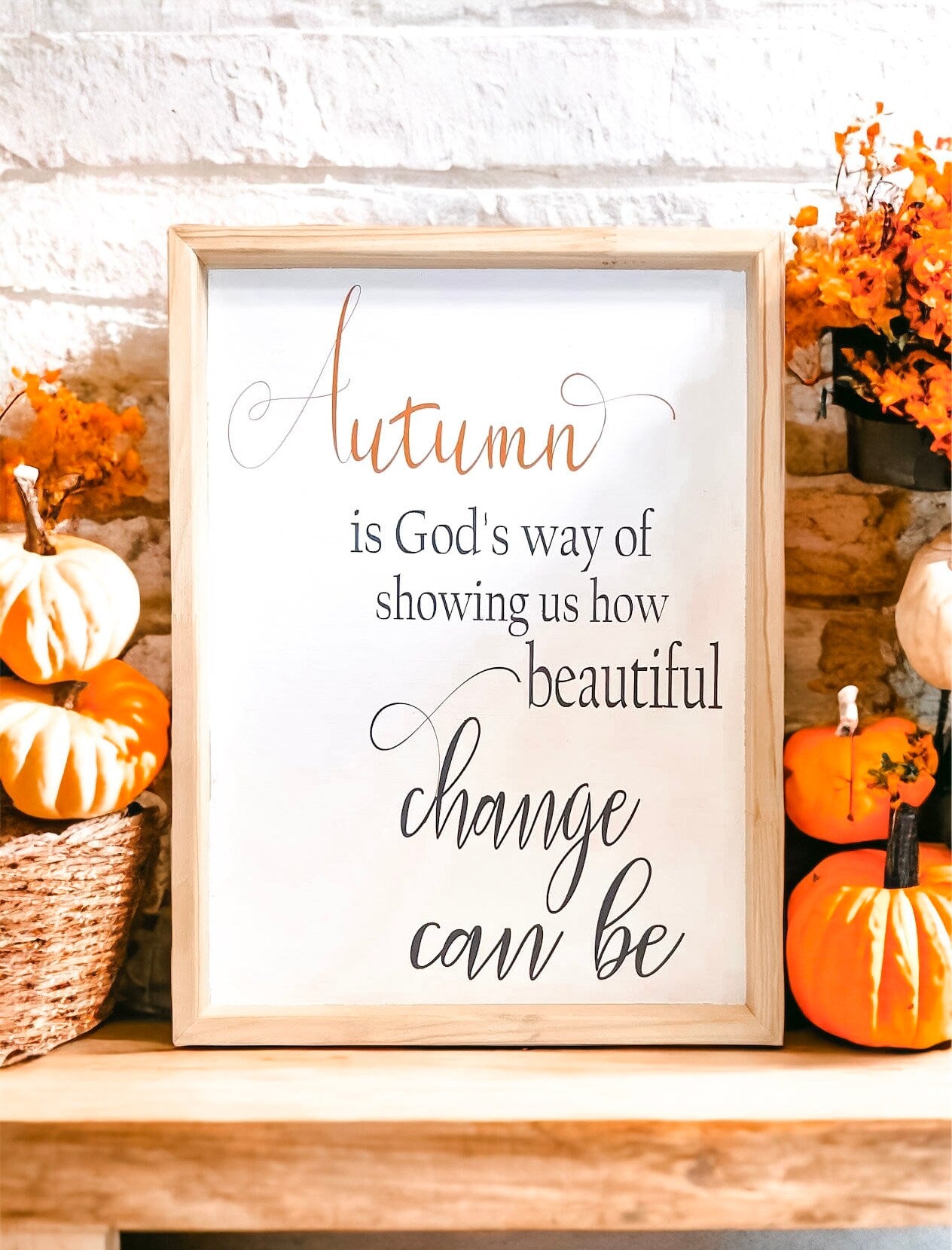 Autumn is Gods Way framed wood sign with copper and black lettering in whitewashed birch frame on white surface with orange pumpkins and dried botanicals product shot