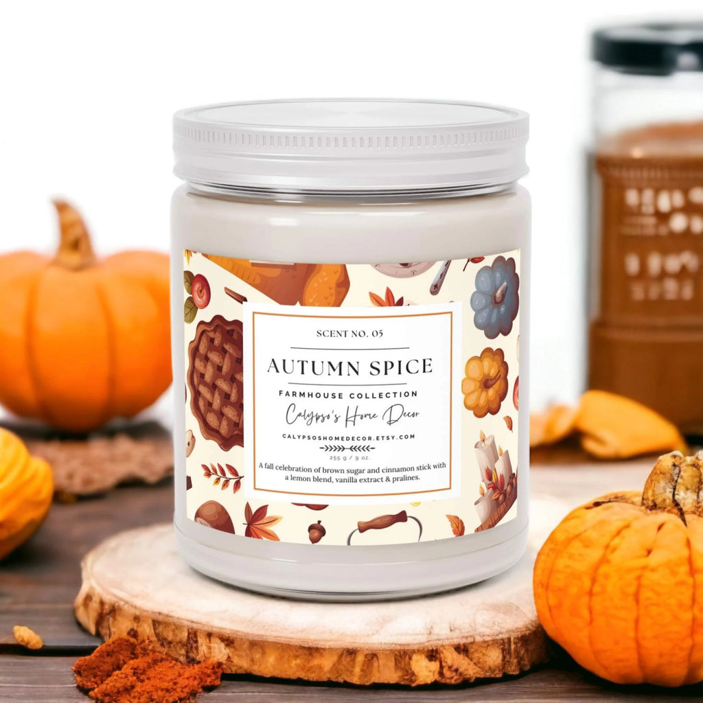 Autumn Spice candle surrounded by fall maple leaves on marble