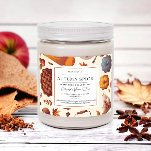 Autumn Spice candle with pine cone and pumpkin on wood table