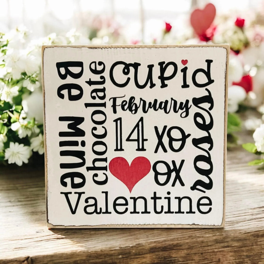 Valentine sayings wood block on rustic wood with red and white flowers and fairy lights