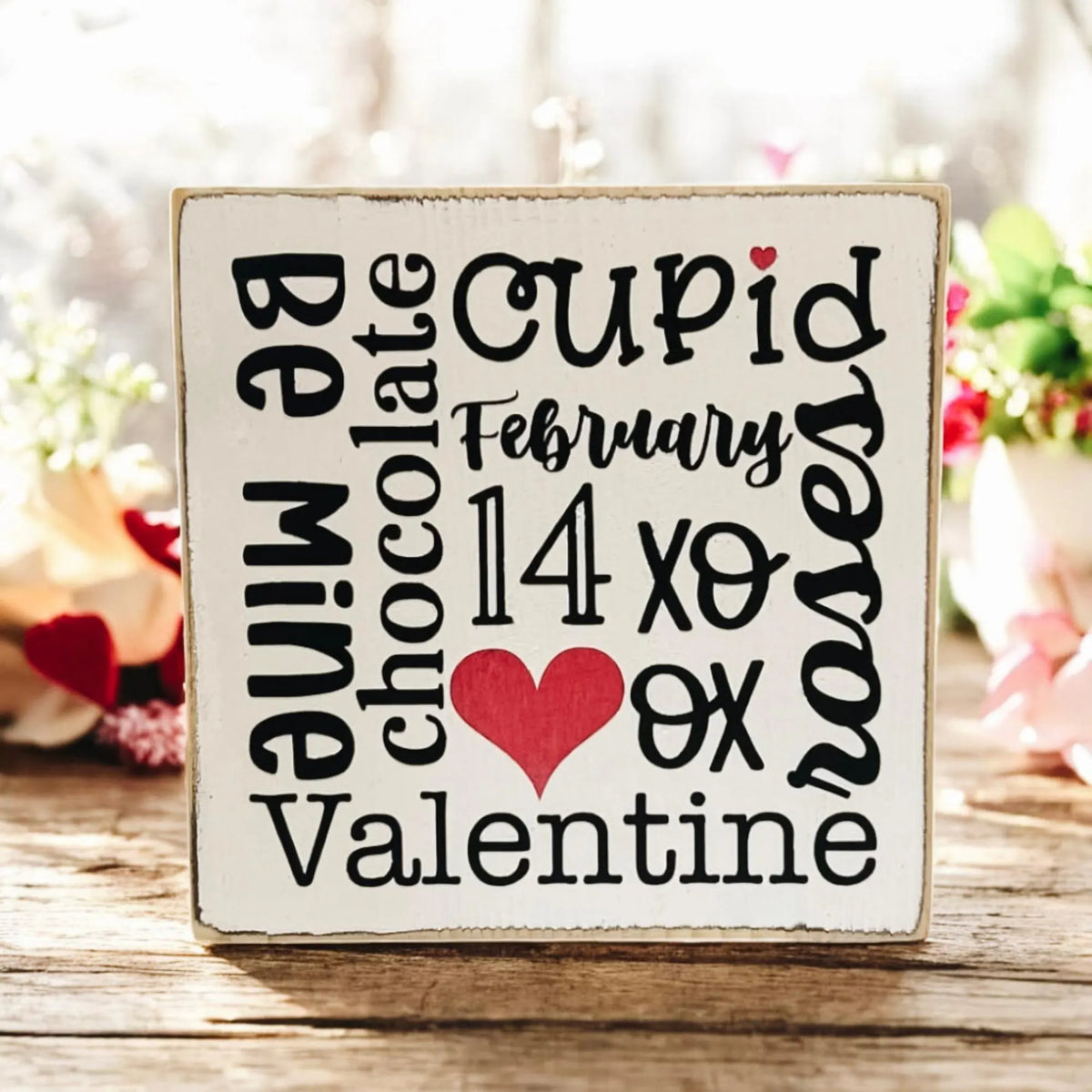 Valentine sayings wood block front view on rustic wood with white flowers