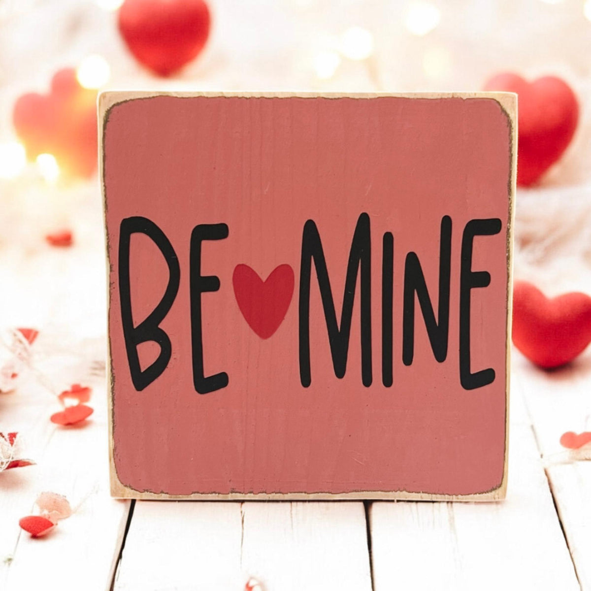 Be Mine Valentine wood block sign on rustic wood surface with red roses close up
