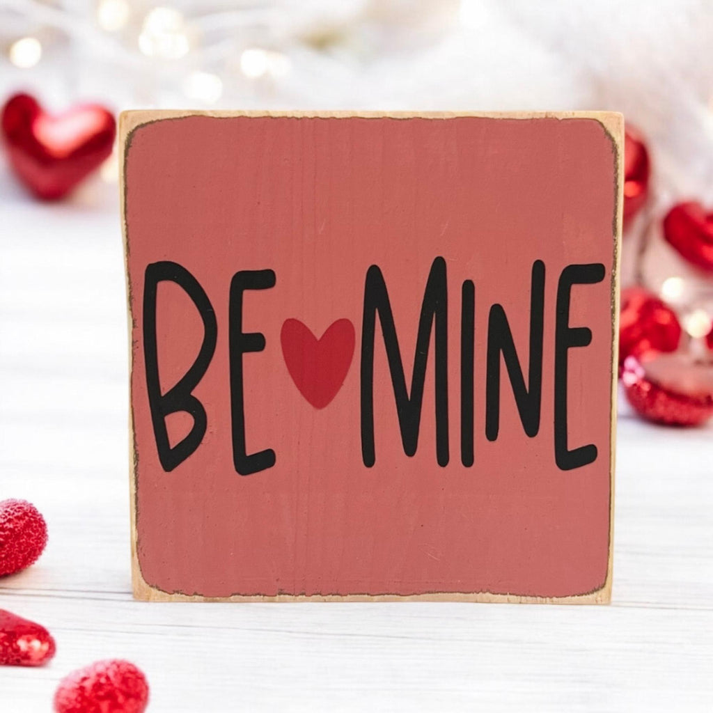 Be Mine Valentine wood block sign on white wood surface with red roses full view