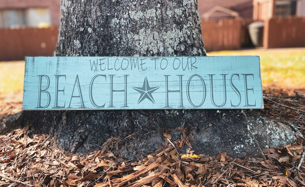Welcome to Our Beach House reclaimed wood sign on white dresser with HOME metal letters and General Store sign