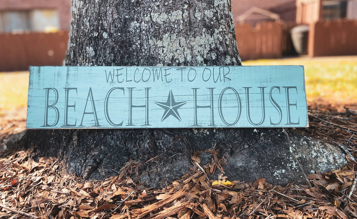 Welcome to Our Beach House reclaimed wood sign on white dresser with HOME metal letters and General Store sign