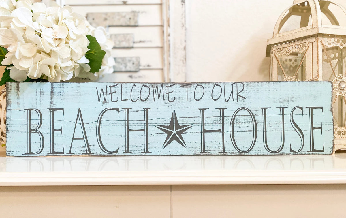 Welcome to Our Beach House reclaimed wood sign on white dresser with white lantern and shutter decor