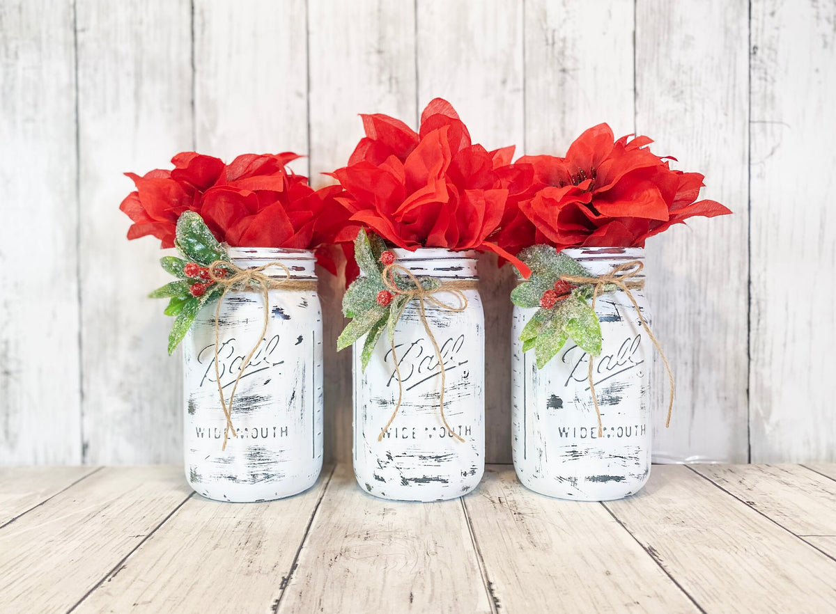 Christmas mason jar set with sparkly holly and red flowers overhead angle
