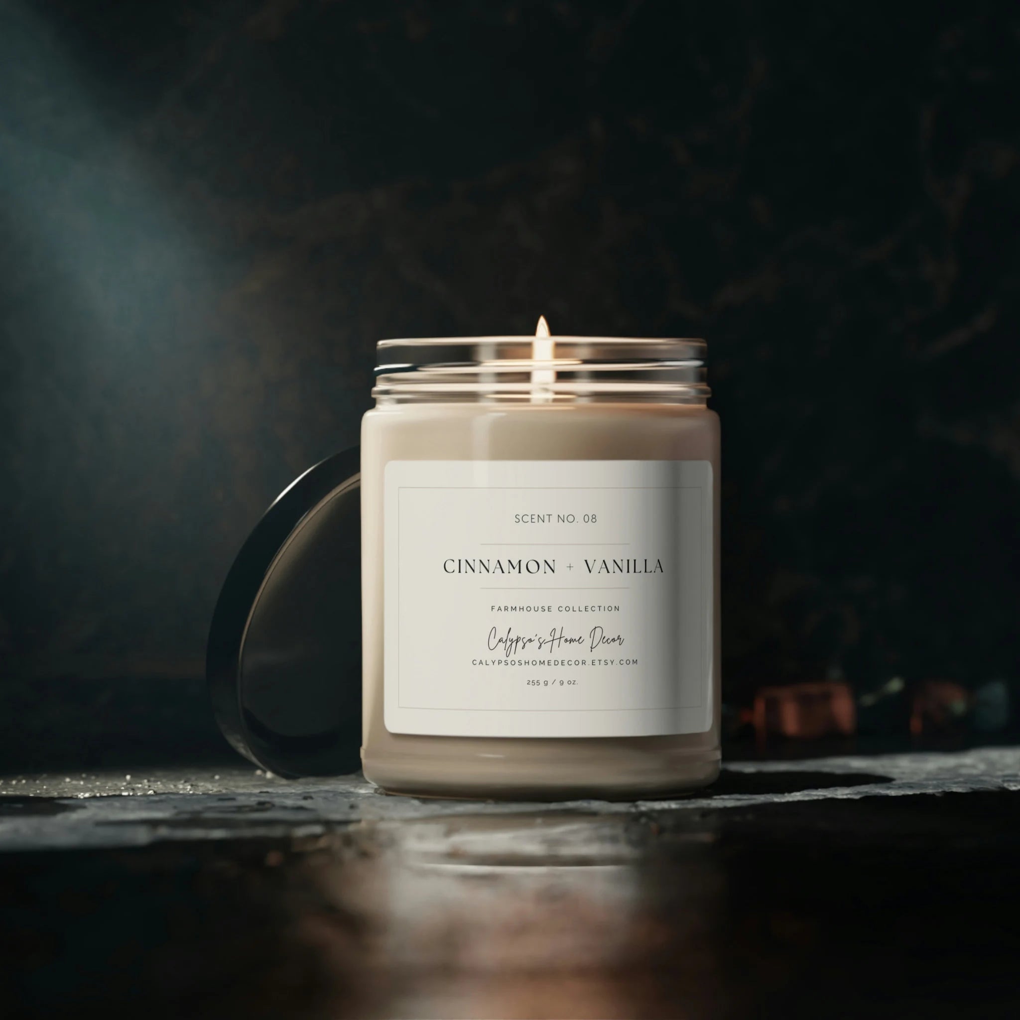 Cinnamon Vanilla candle glowing on dark moody background