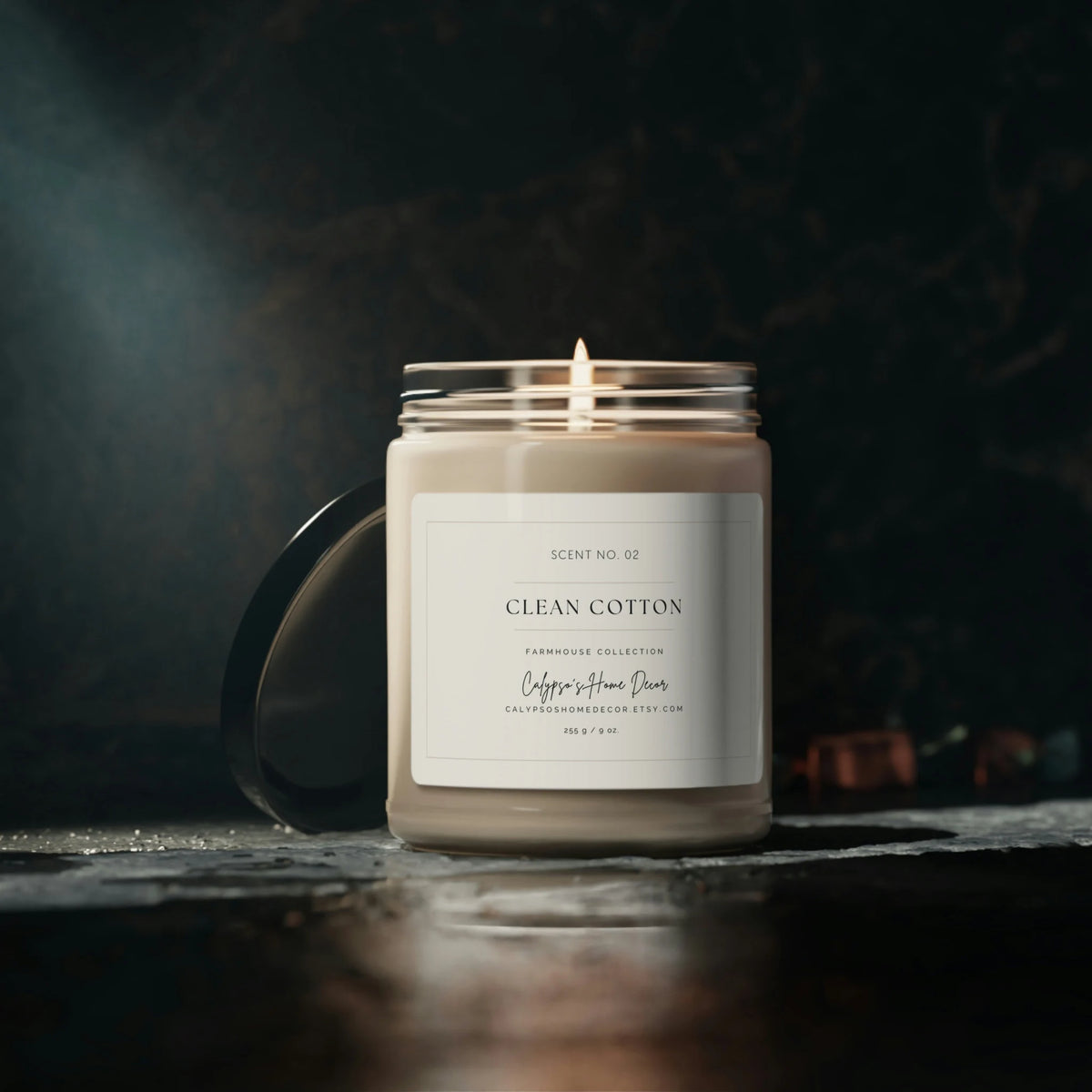 Clean Cotton soy candle Scent No. 02 Farmhouse Collection on white shelf beside succulent plant and stacked books