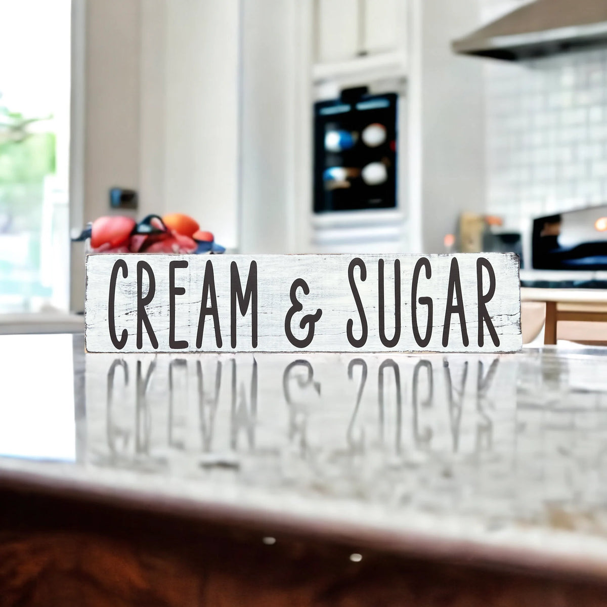 Cream and Sugar distressed white farmhouse wood sign on rustic wood surface with red apple and white ceramic jars in background