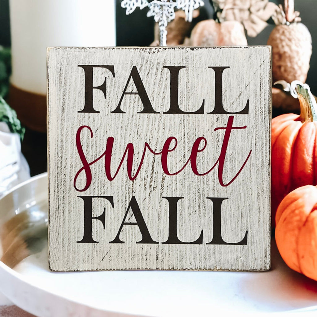 Fall Sweet Fall distressed white wood block sign on white tray with orange glitter pumpkins and fall leaves
