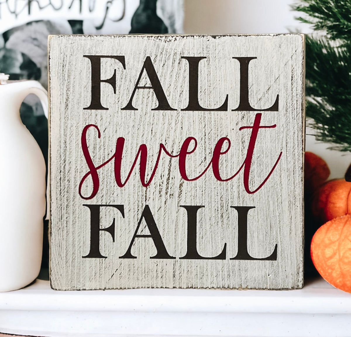 Fall Sweet Fall distressed white wood block sign on tiered tray with orange pumpkins and fall leaves