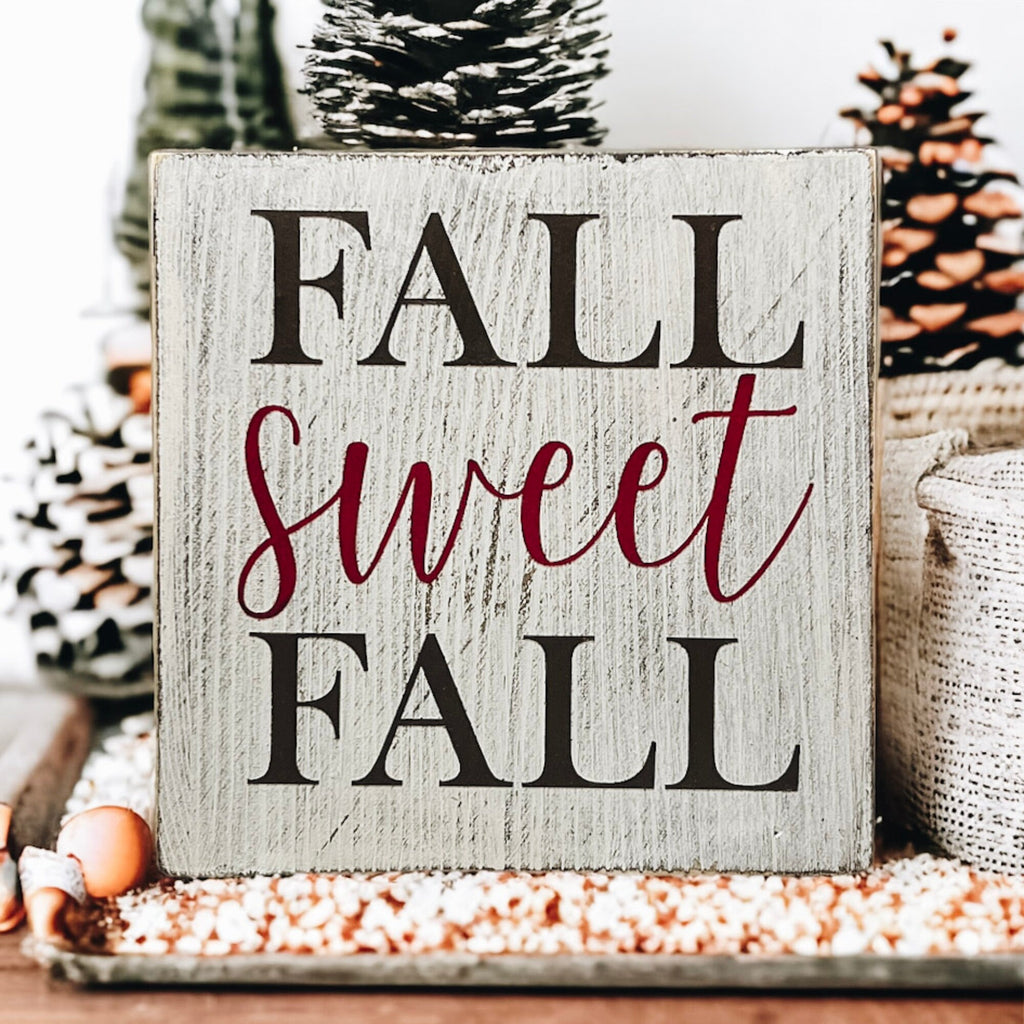 Fall Sweet Fall distressed white wood block sign on white mantel with white jug and orange pumpkins and pine tree