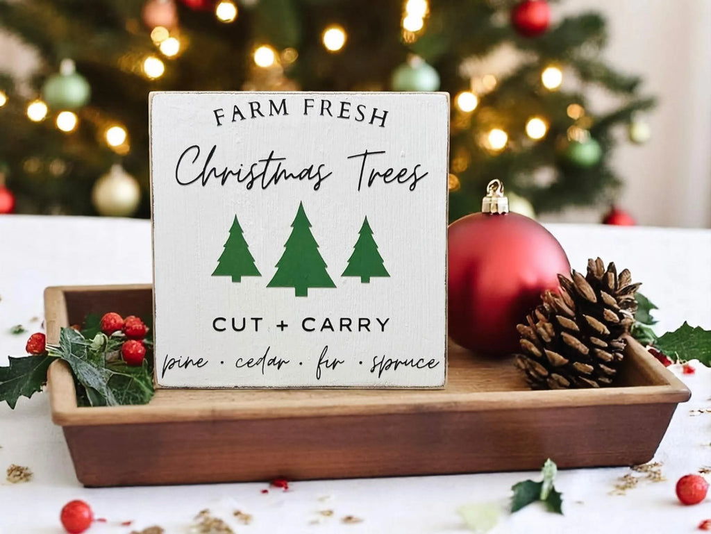 Farm Fresh Christmas Trees wood block sign in wooden tray with pinecones and red ornaments