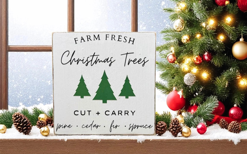 Farm Fresh Christmas Trees wood block sign on wood slice with Christmas tree and ornaments in background