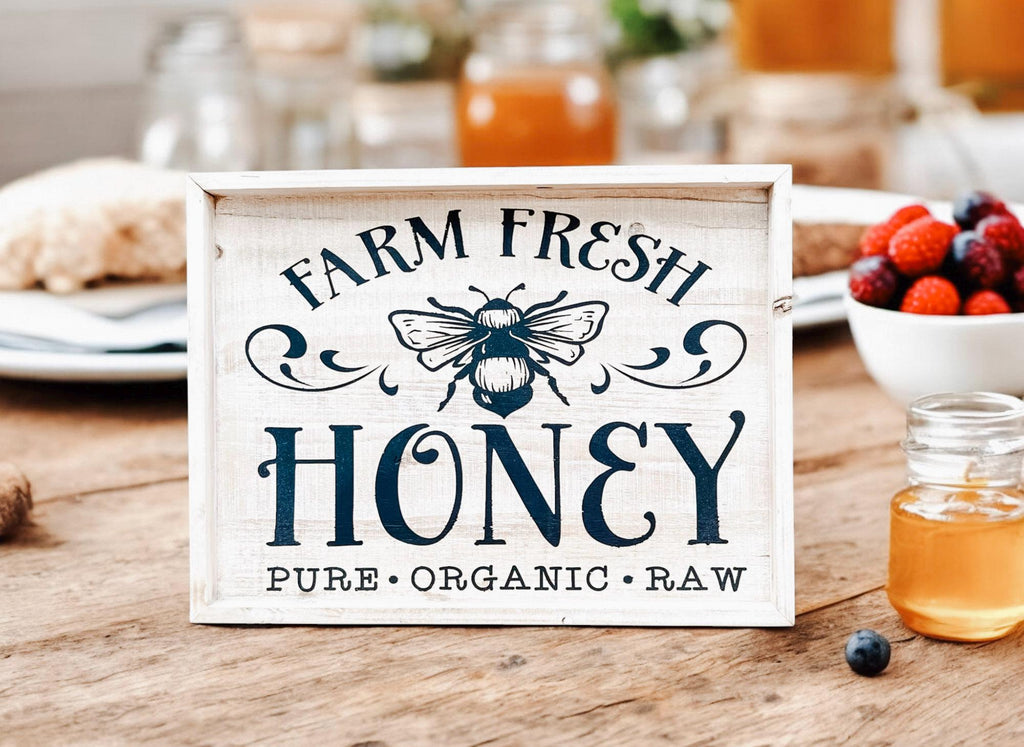 Farm Fresh Honey framed reclaimed wood sign with navy bee graphic and chalk paste lettering in distressed whitewash frame on rustic wood surface product hero shot