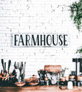 Farmhouse sign hung above kitchen sideboard with copper utensils