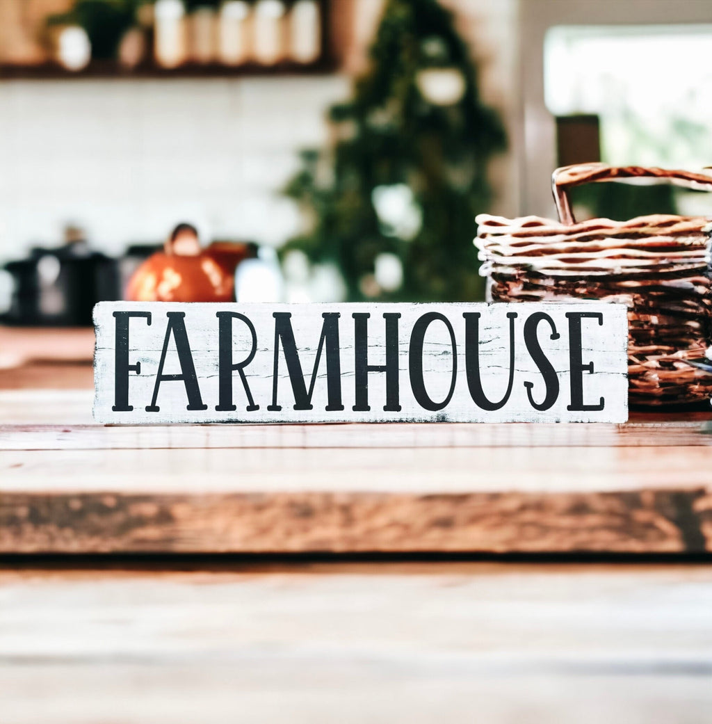 Farmhouse sign leaning on rustic wood wall with apple bowl