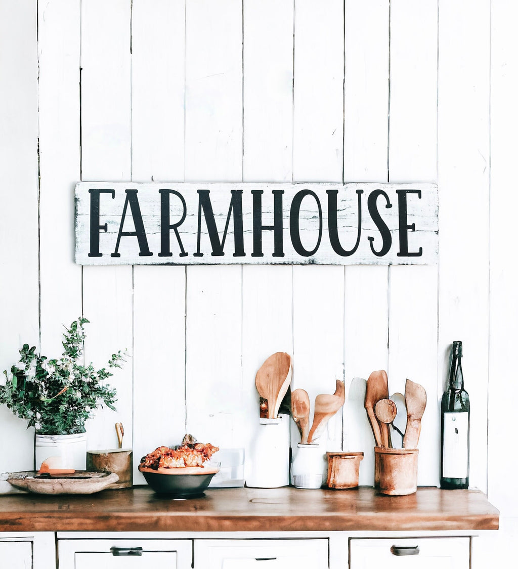 Farmhouse sign hung on shiplap wall above dining table