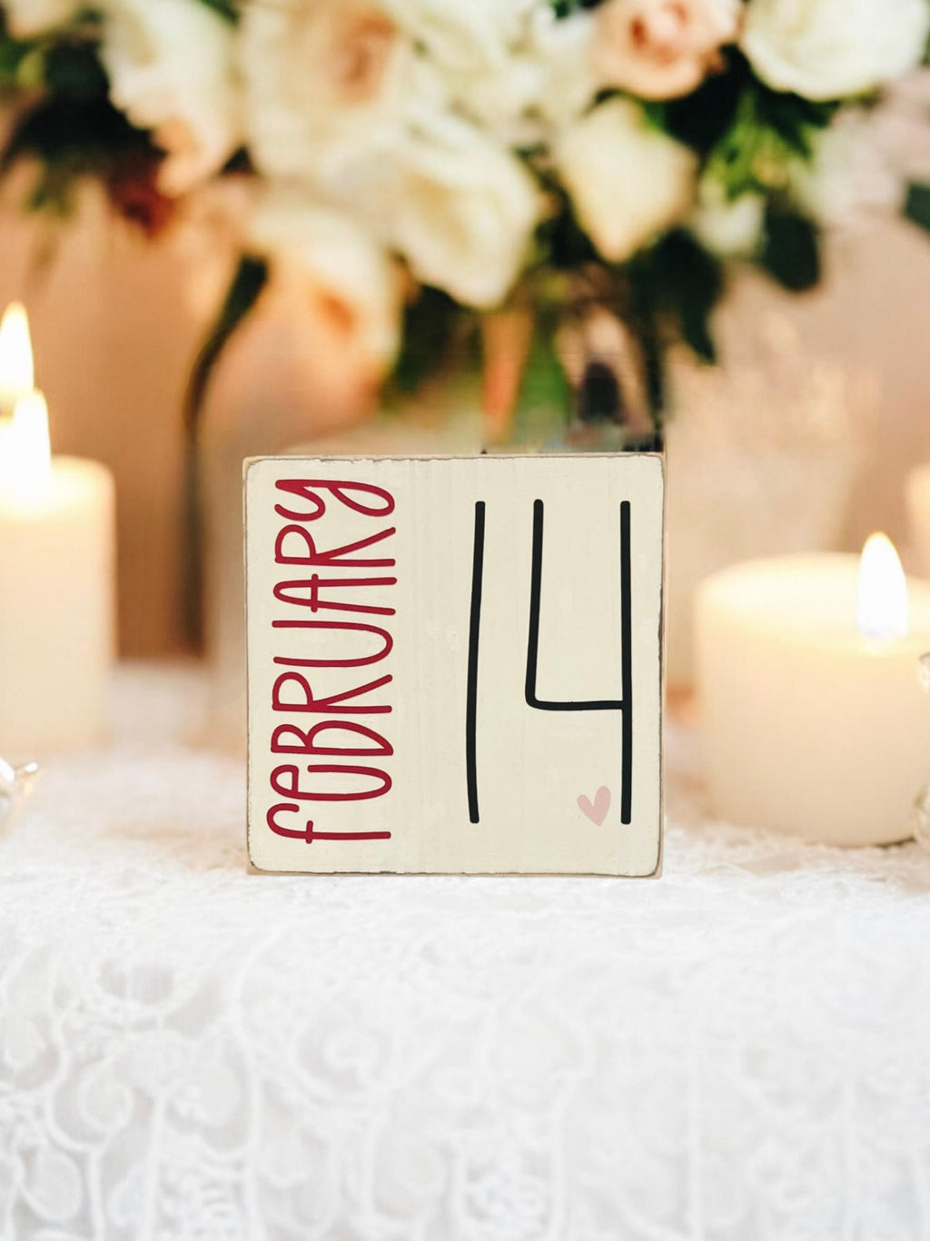 February 14 sign close up showing red February lettering and black 14 with heart detail