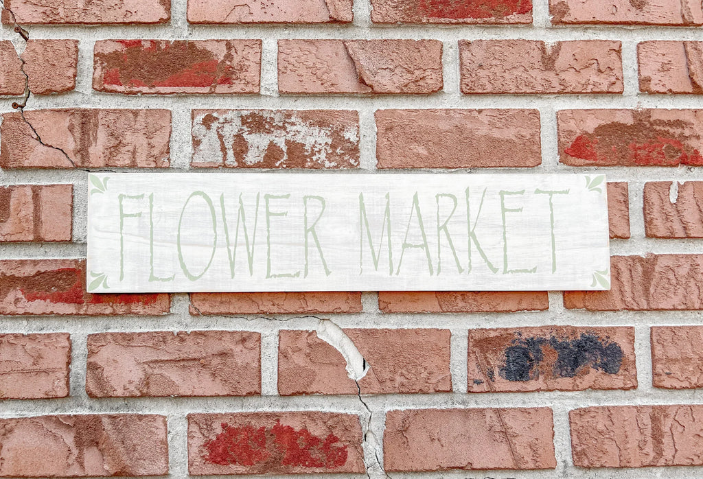 Flower Market sign styled with white lantern and mixed flower bouquet on white console