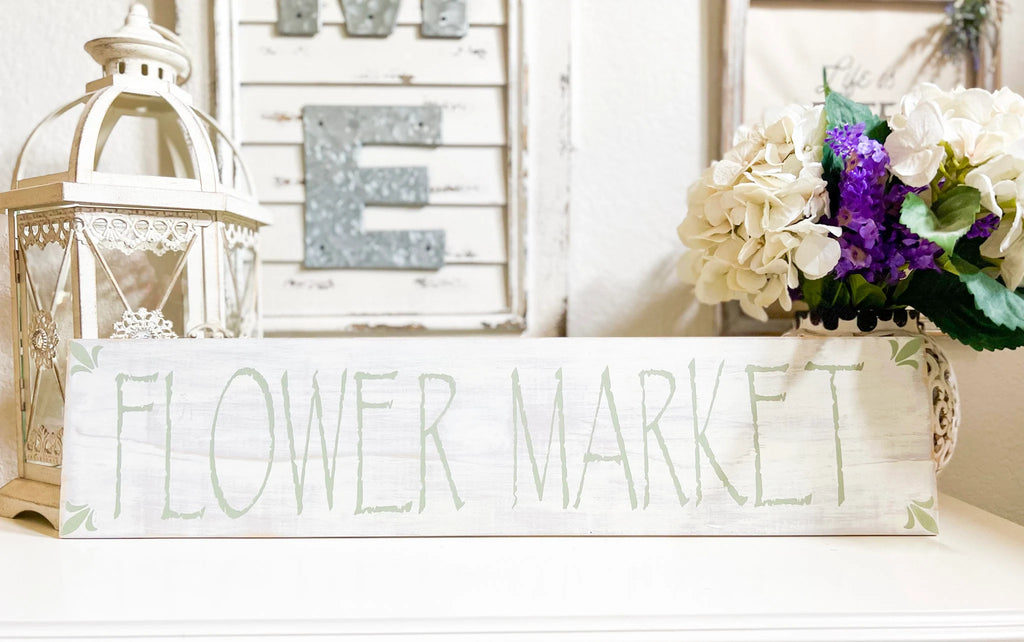 Flower Market sign close up showing sage green hand-painted lettering on white pine