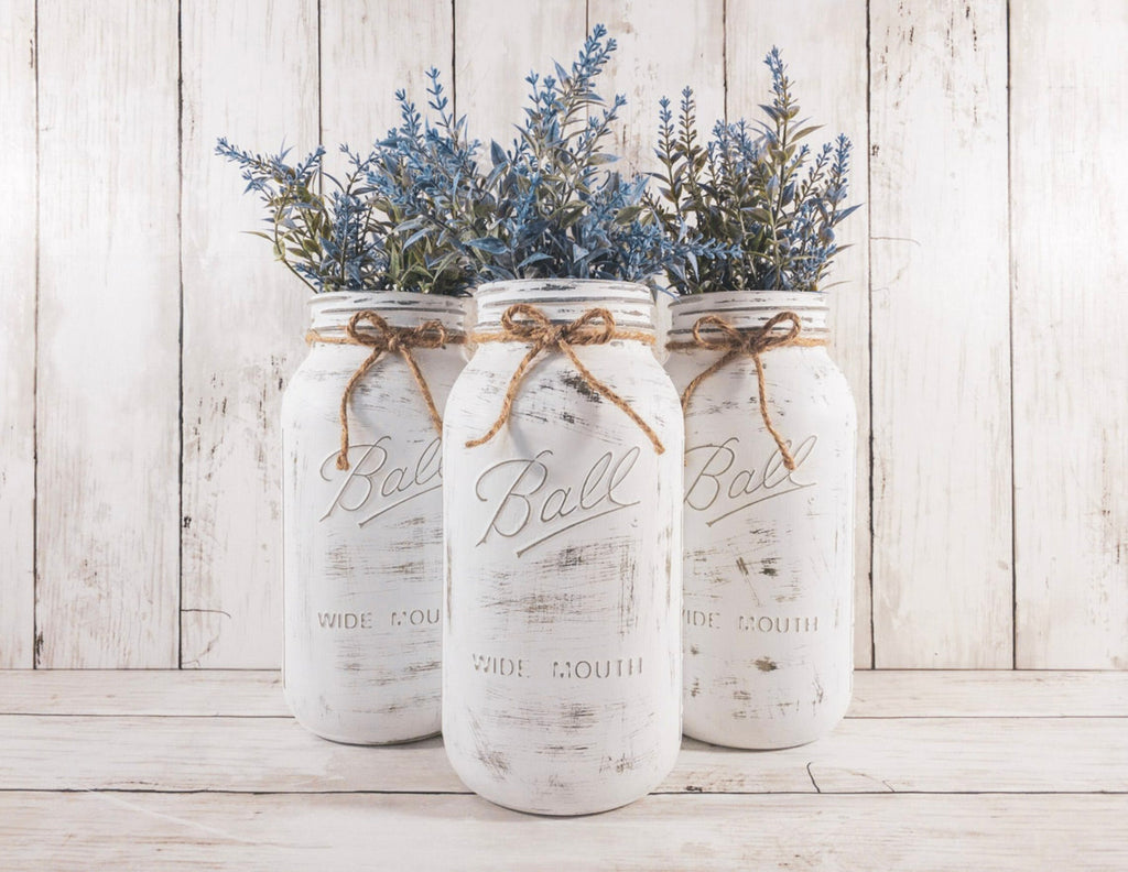 Set of 3 distressed white Ball mason jars with jute twine bows and blue lavender greenery angled view