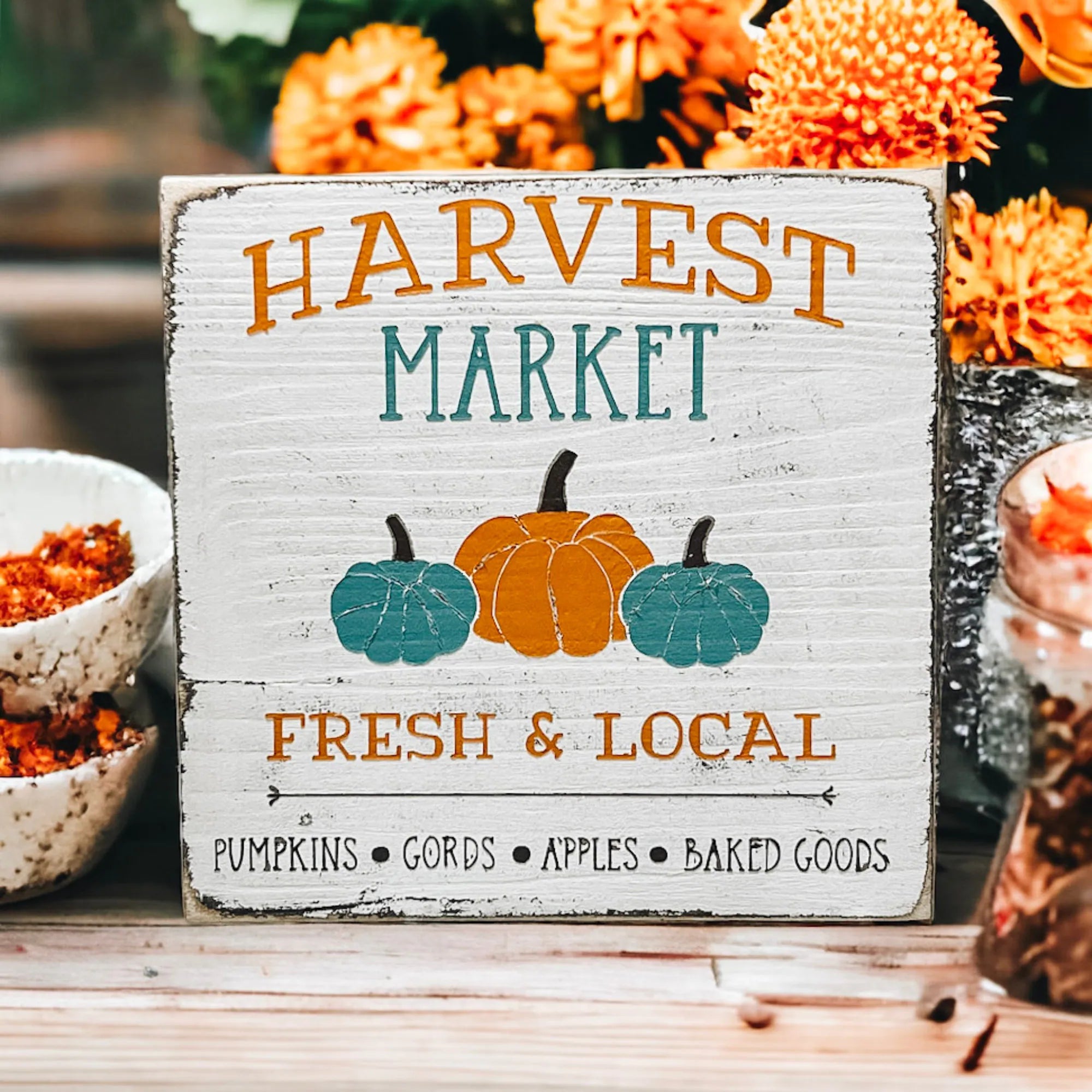 Harvest Market sign with fall mums and white pumpkin bright background