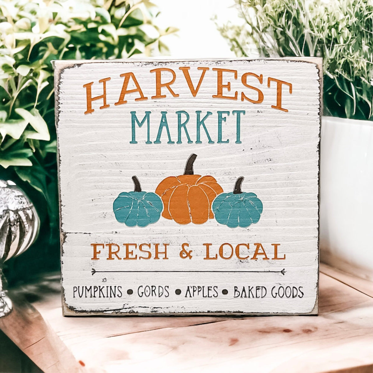 Harvest Market sign close up on distressed white finish with pumpkin details