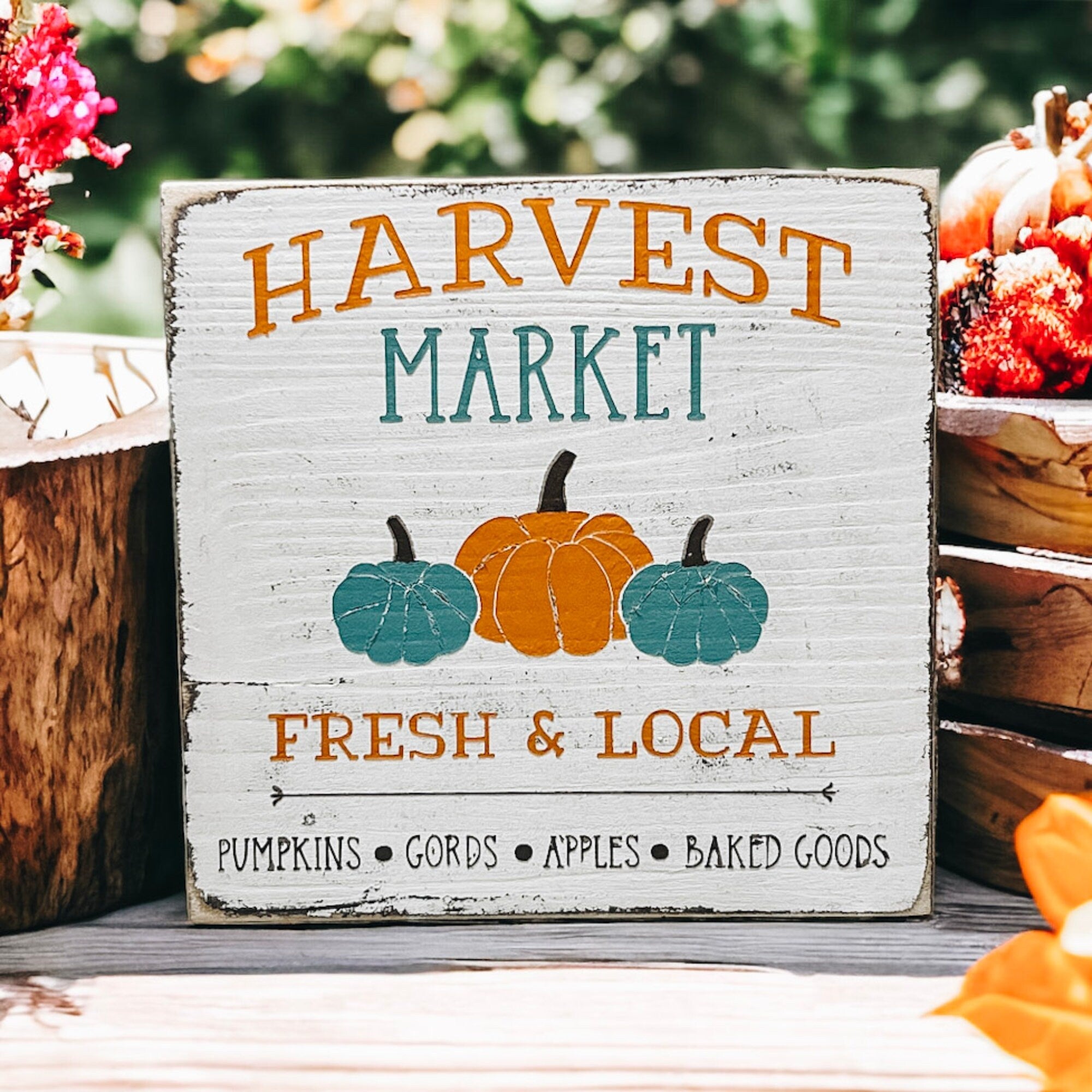 Harvest Market sign with wicker basket and fall flowers on porch