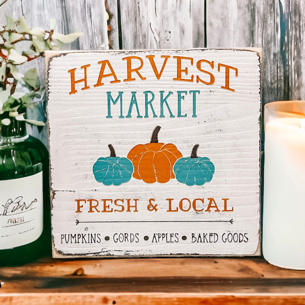 Harvest Market sign with orange flowers and spice jars on wood table