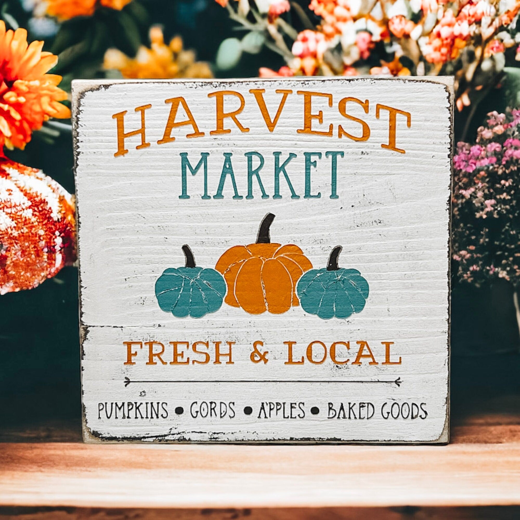 Harvest Market sign on wood shelf with greenery and silver ornament