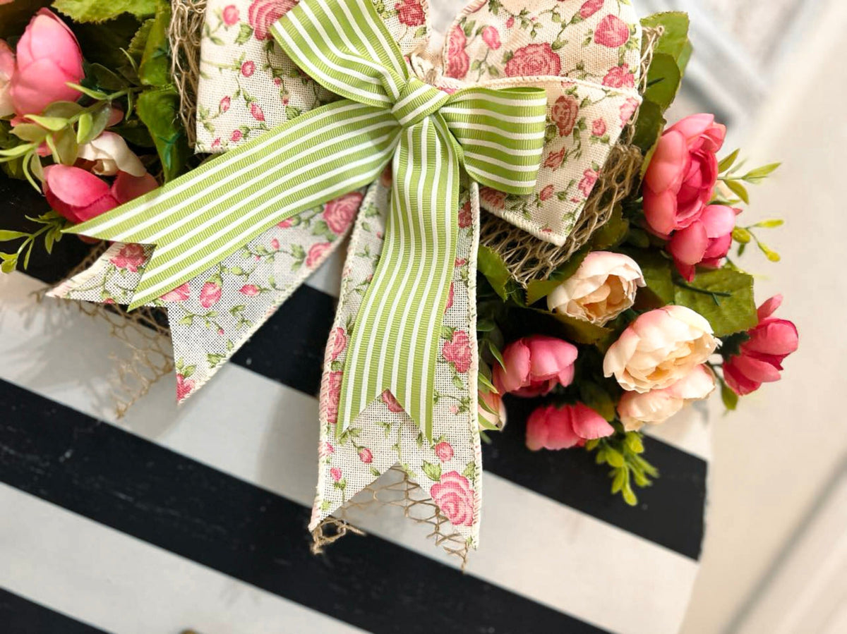 Hello black and white striped round door hanger with pink floral bow close up of bow and pink roses detail