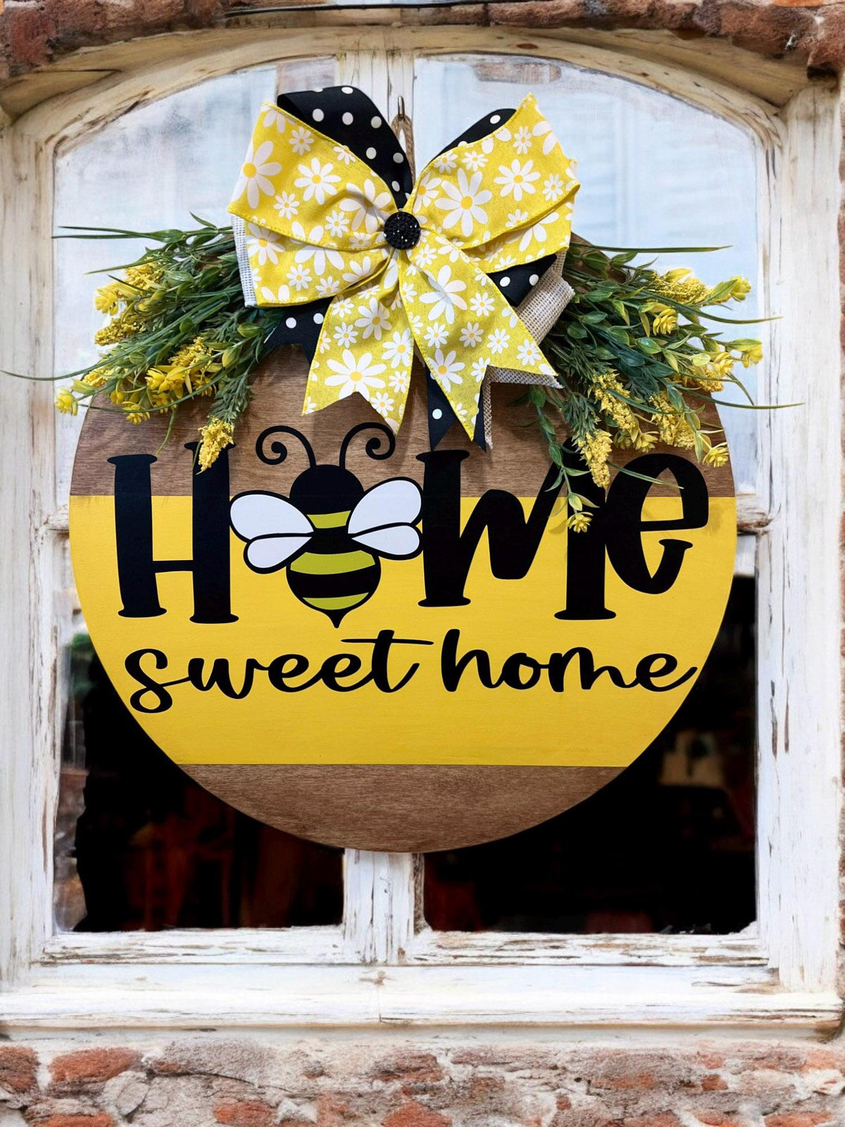 Home Sweet Home bee round pine door hanger yellow and walnut two-tone with daisy polka dot bow and wildflower greenery product hero shot on white background