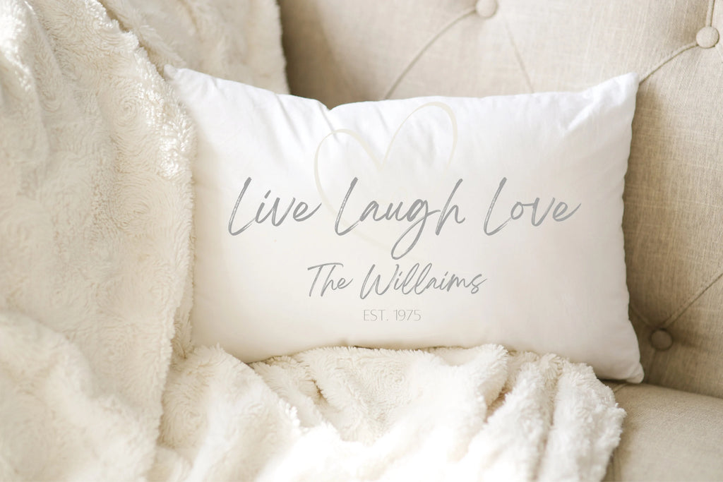 Personalized Live Laugh Love lumbar pillow lifestyle shot on white distressed wood surface