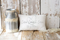 Personalized Live Laugh Love lumbar pillow on cream tufted sofa with gray knit blanket