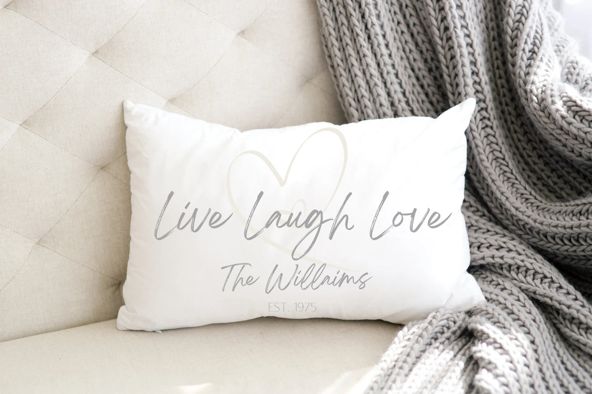 Personalized Live Laugh Love lumbar pillow product shot on white distressed wood surface full view
