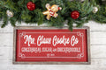 Mrs Claus Cookie Co framed Christmas sign crimson red with white script and serif lettering in distressed gray wood frame product hero shot on white background