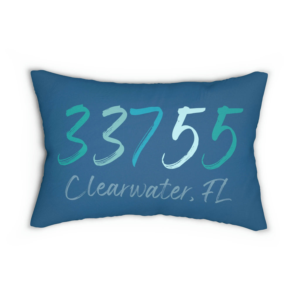 Personalized 33755 Clearwater FL navy lumbar pillow on woven rattan chair with blue diamond rug lifestyle shot