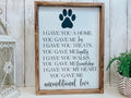 Personalized pet memorial sign with dark navy paw print and unconditional love lettering on white background with dark walnut frame