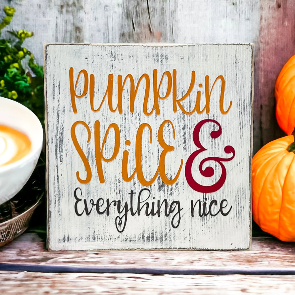 Pumpkin Spice and Everything Nice distressed whitewash wood block sign with amber script orange serif and burgundy ampersand product hero shot on white background