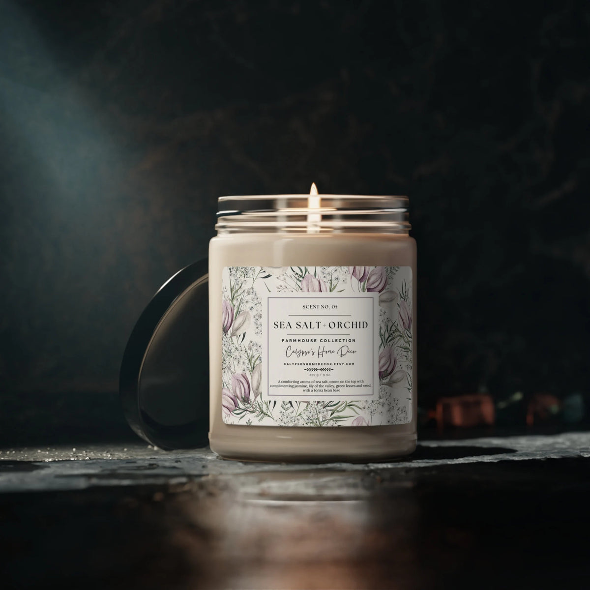 Sea Salt Orchid candle in glass jar with black lid on rustic wood dock with ocean background