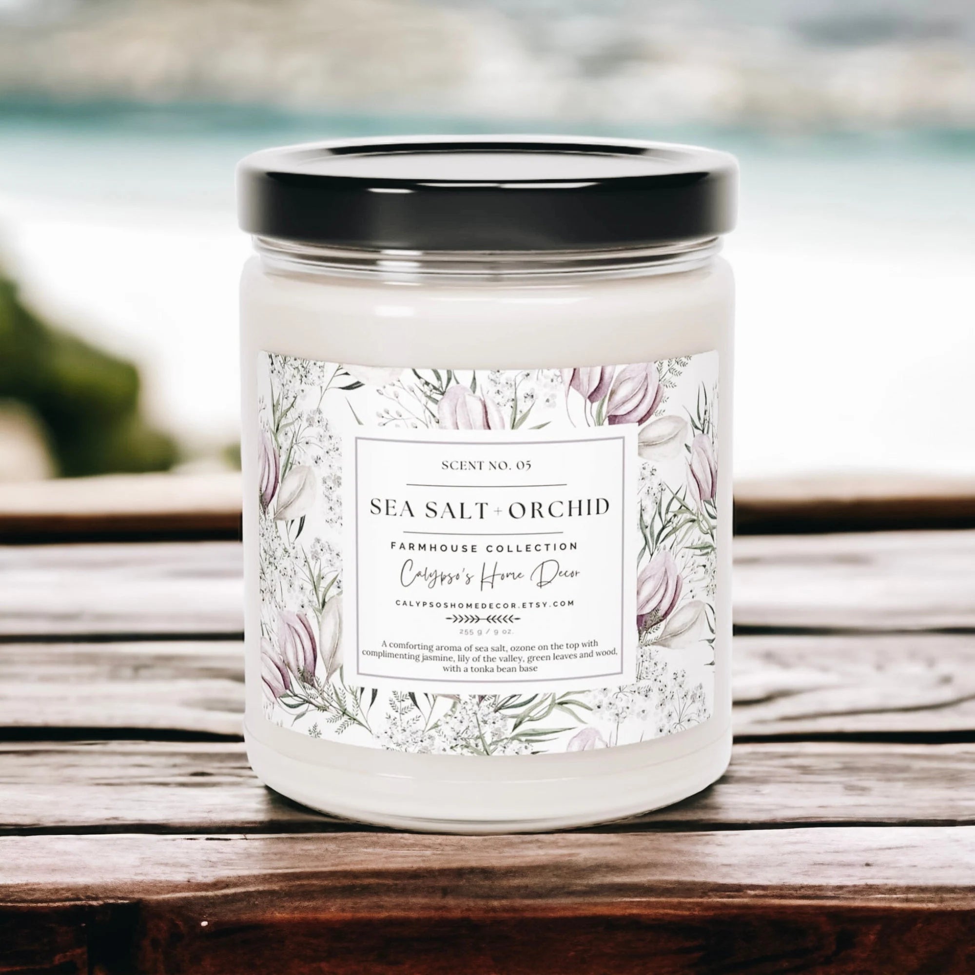 Sea Salt Orchid candle on wood cutting board with green candle and white pot plant in background