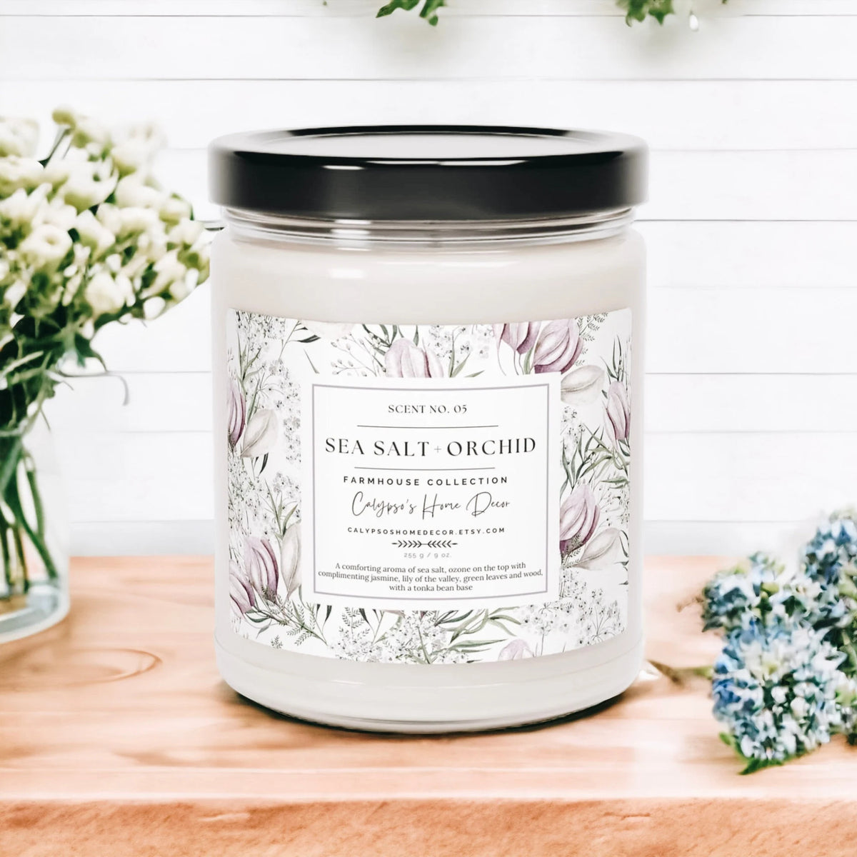 Sea Salt Orchid candle on white wood shelf with lily of the valley bouquet in background